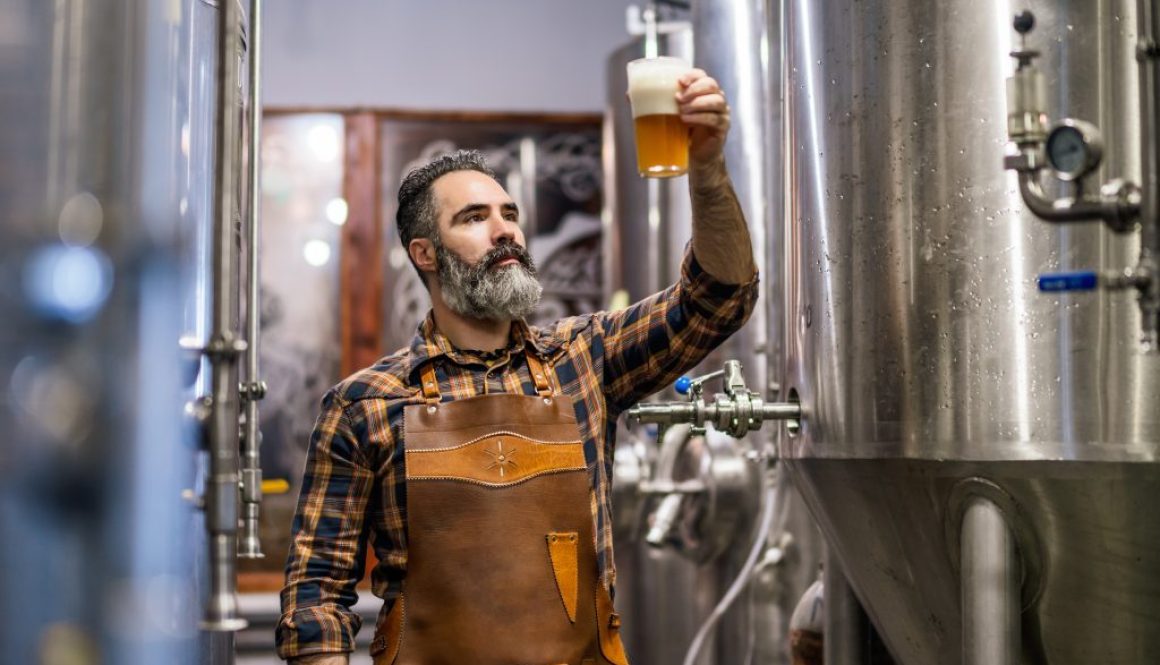 Bearded,Brewery,Master,Holding,Glass,Of,Beer,And,Evaluating,Its